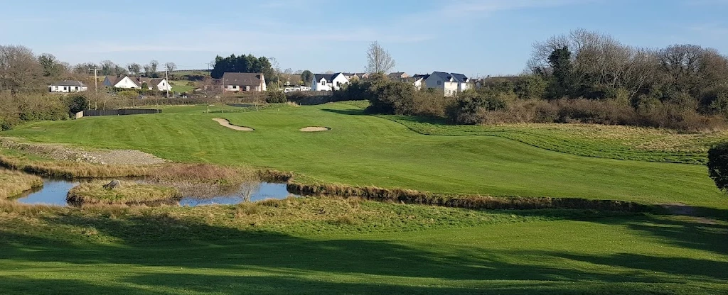 Kirkistown Castle Golf Club — a bunkered green and pond on the links Kirkistown Castle Golf Club — a bunkered green and pond on the links